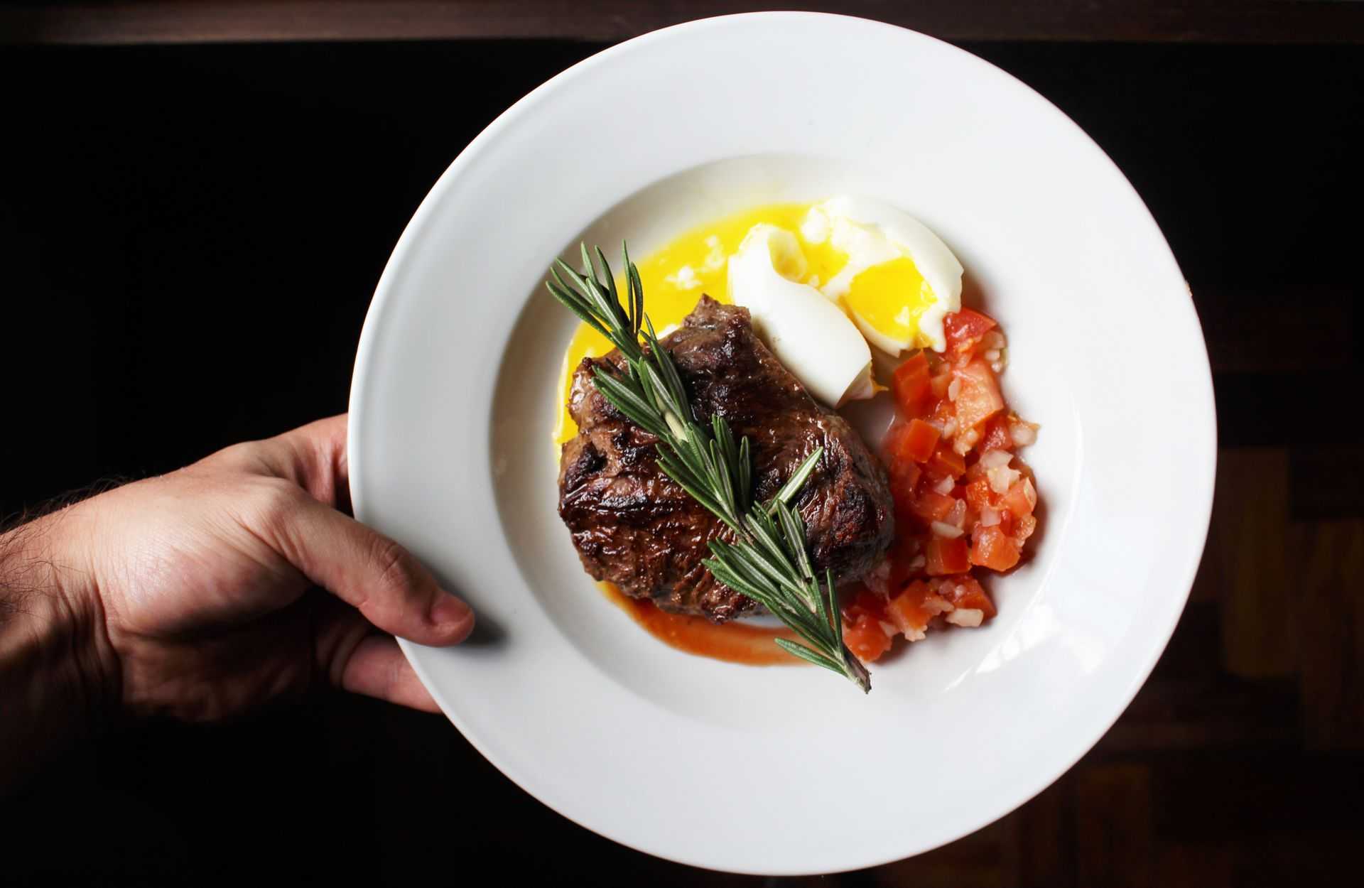 Steak and eggs with a side of tomatoes